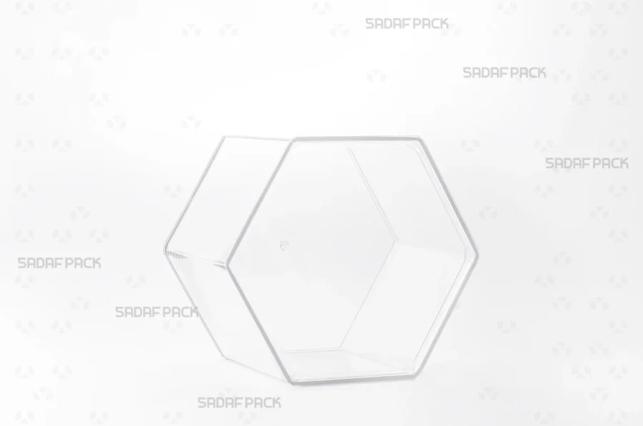 A three-quarter view of the Sadaf Pack Hexagon Tall crystal container, designed for premium packaging of sweets, nuts, and dried fruits.