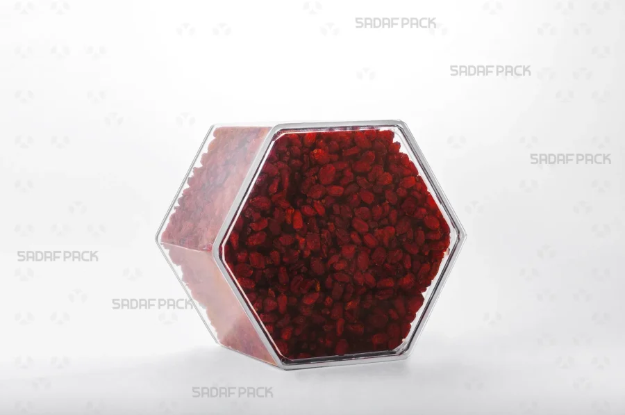 An elegant three-quarter angle view of the export-quality Hexagon Tall container filled with Barberries, highlighting its excellent product visibility.