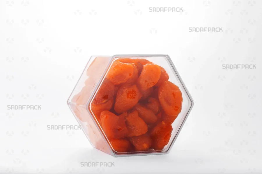 An elegant three-quarter angle view of the export-quality Hexagon Tall container filled with Dried Prunes, highlighting its excellent product visibility.