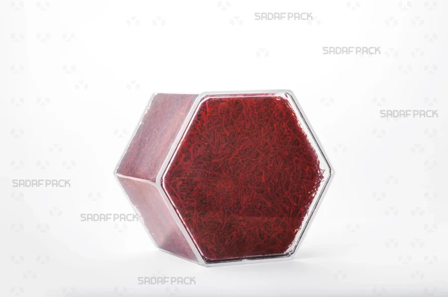 An elegant three-quarter angle view of the export-quality Hexagon Tall container filled with saffron, highlighting its excellent product visibility.