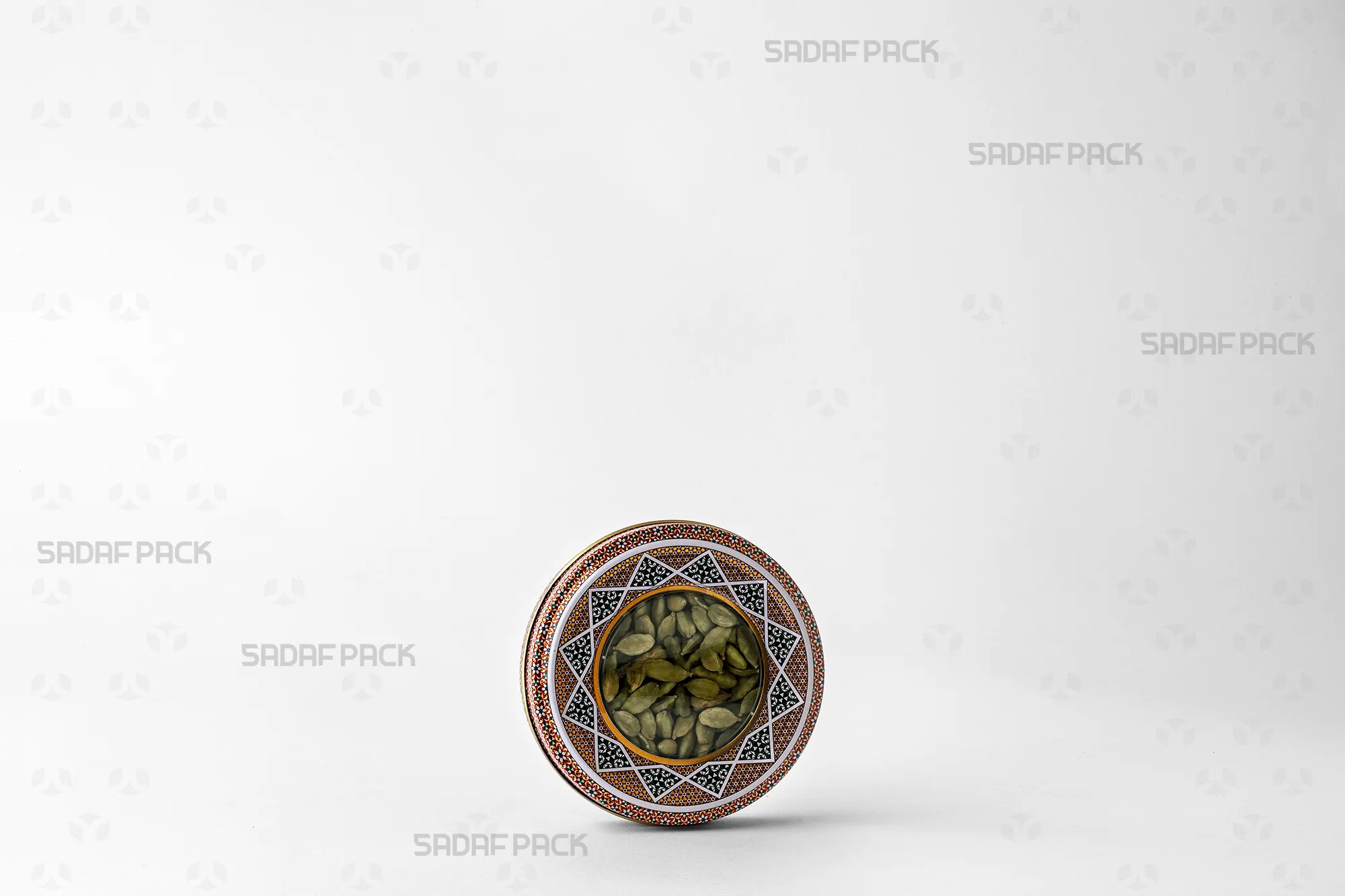 A three-quarter view of the 10 gram Metal Tin filled with cardamom, ideal for export and preserving freshness.