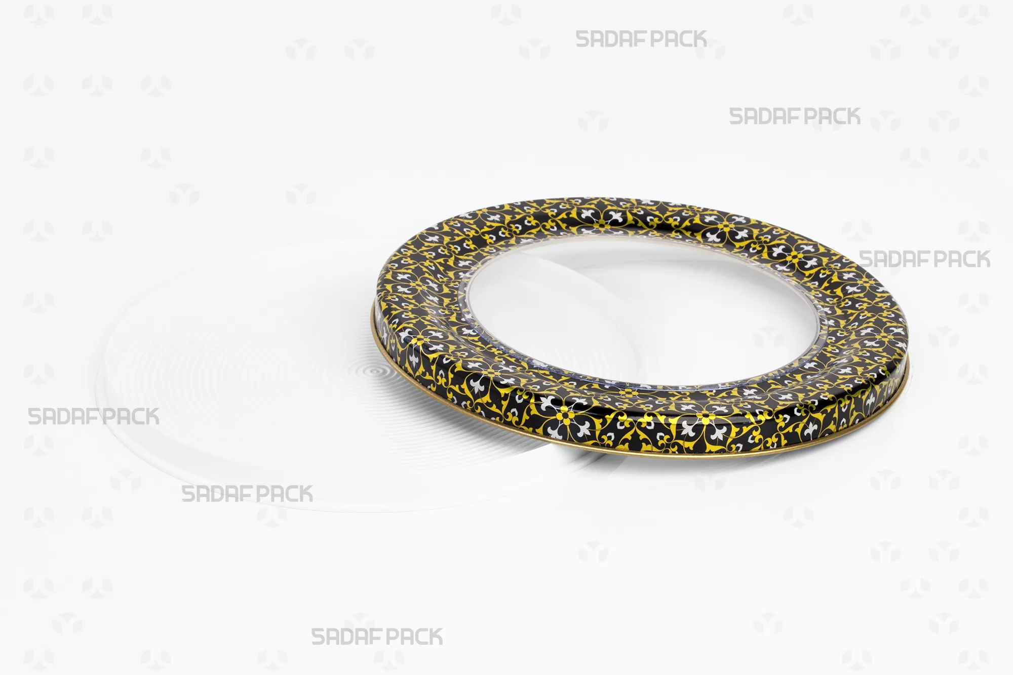 Top-down view of the empty 17 Metal España Raised Bottom tin by Sadaf Pack, with the open lid placed next to the base to display the internal capacity and the black, gold, and white design.