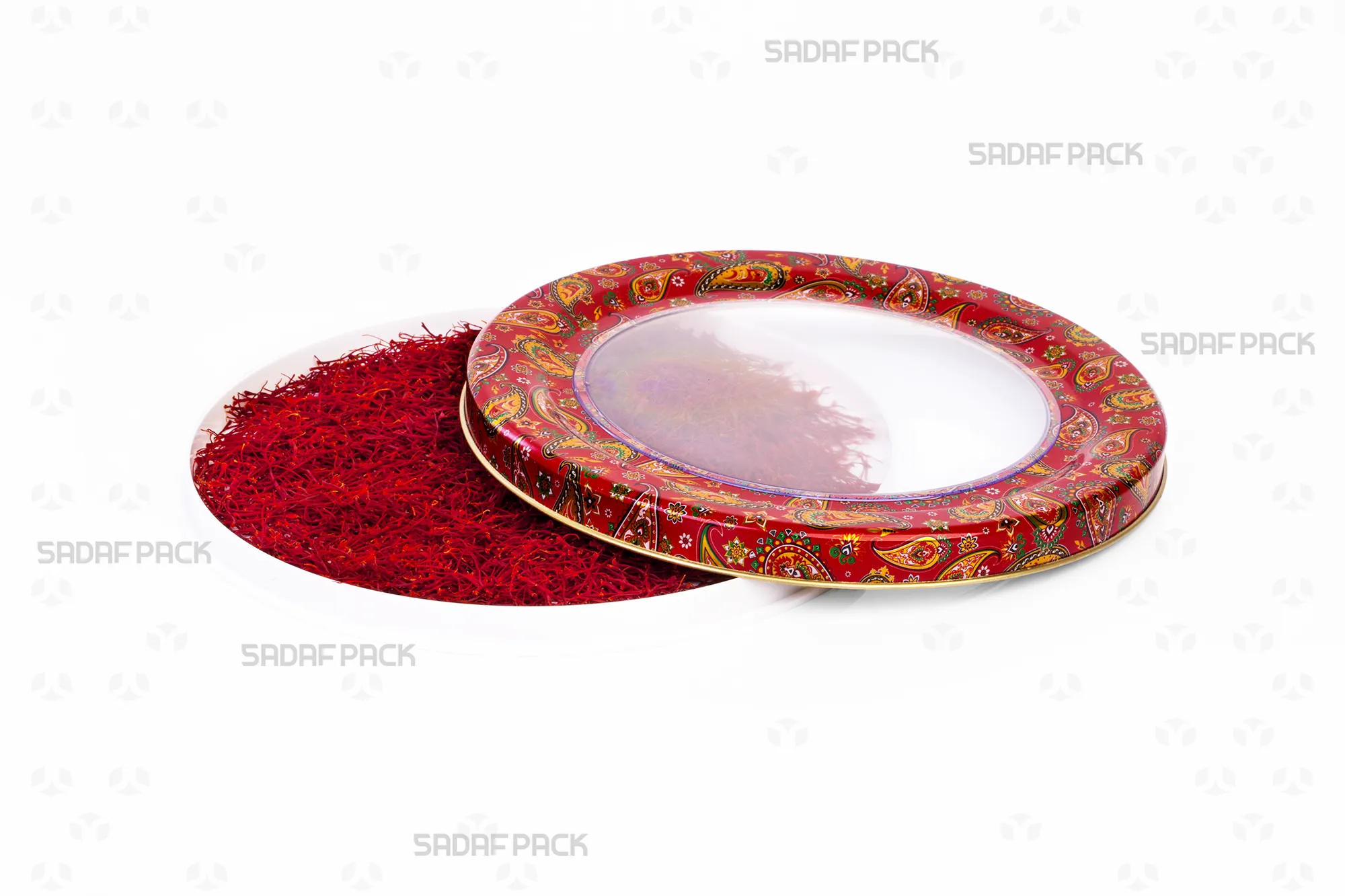 Top-down view of the 17 Metal España Raised Bottom tin by Sadaf Pack, showing the open lid beside the base filled with saffron, highlighting the red Termeh pattern.