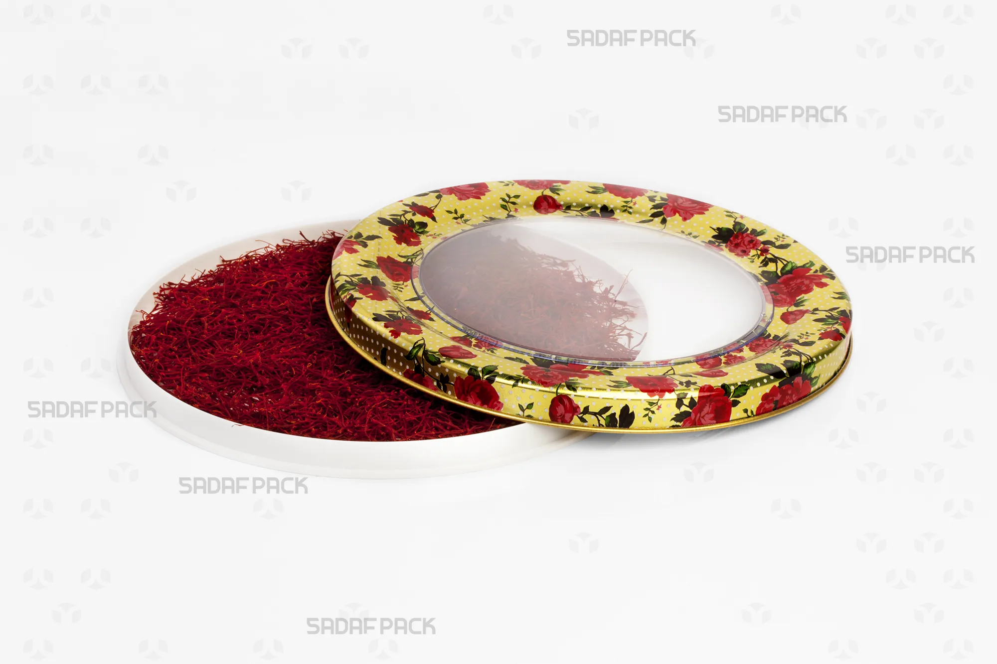 Top-down view of the 17 Metal España Raised Bottom tin by Sadaf Pack, showing the open lid beside the base filled with saffron, highlighting the rose gold finish.