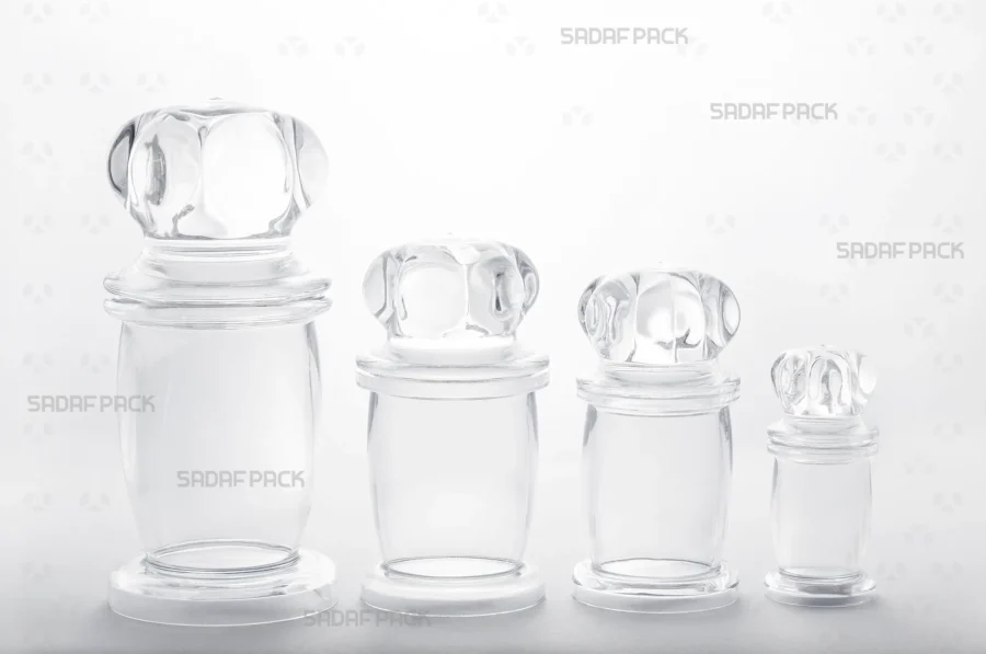 The complete collection of Milad series crystal containers, numbers 1 through 4, displayed together to show the range of sizes, presented by Sadaf Pack.